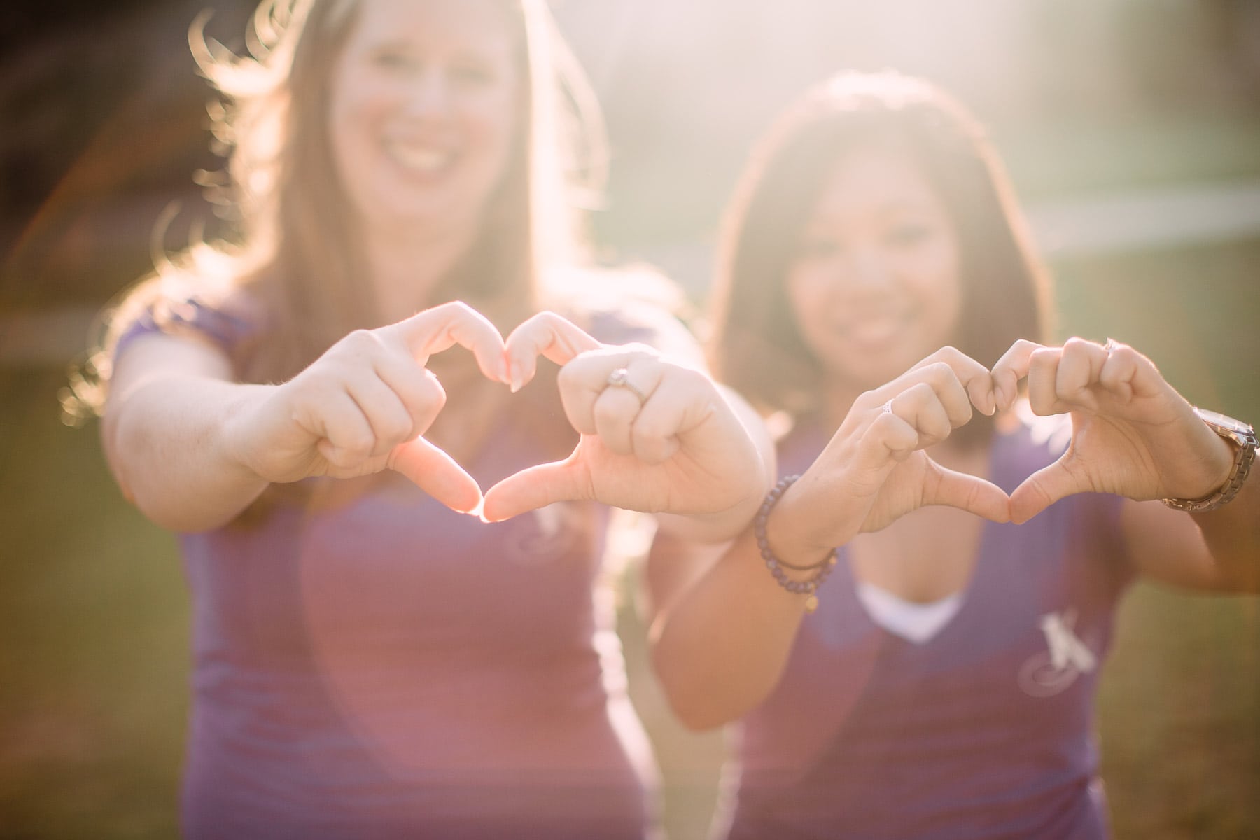 team members holding heart hand signs