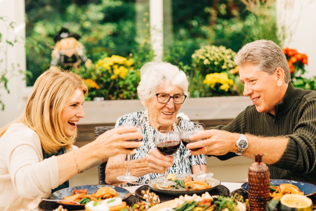 couple dining with older woman