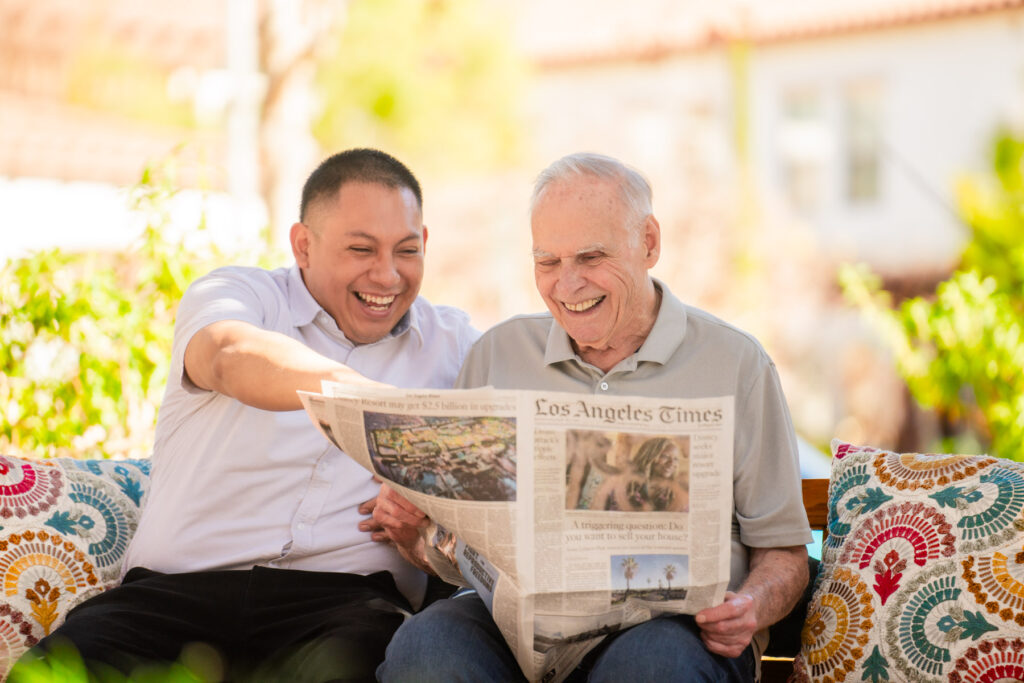 two men reading a newspaper