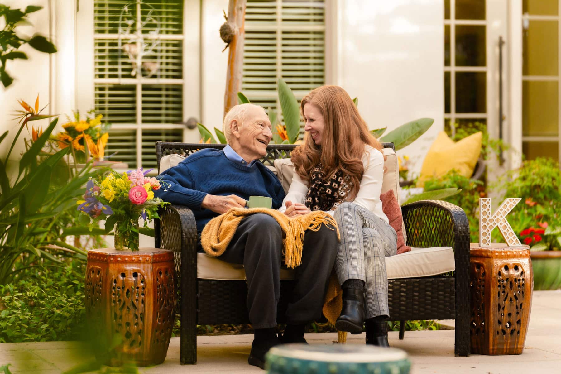 older man sitting with woman on bench