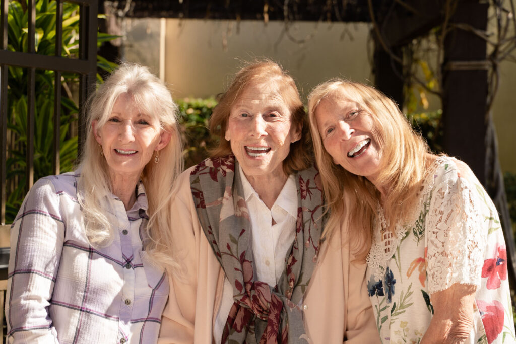 mom and daughters sitting outside