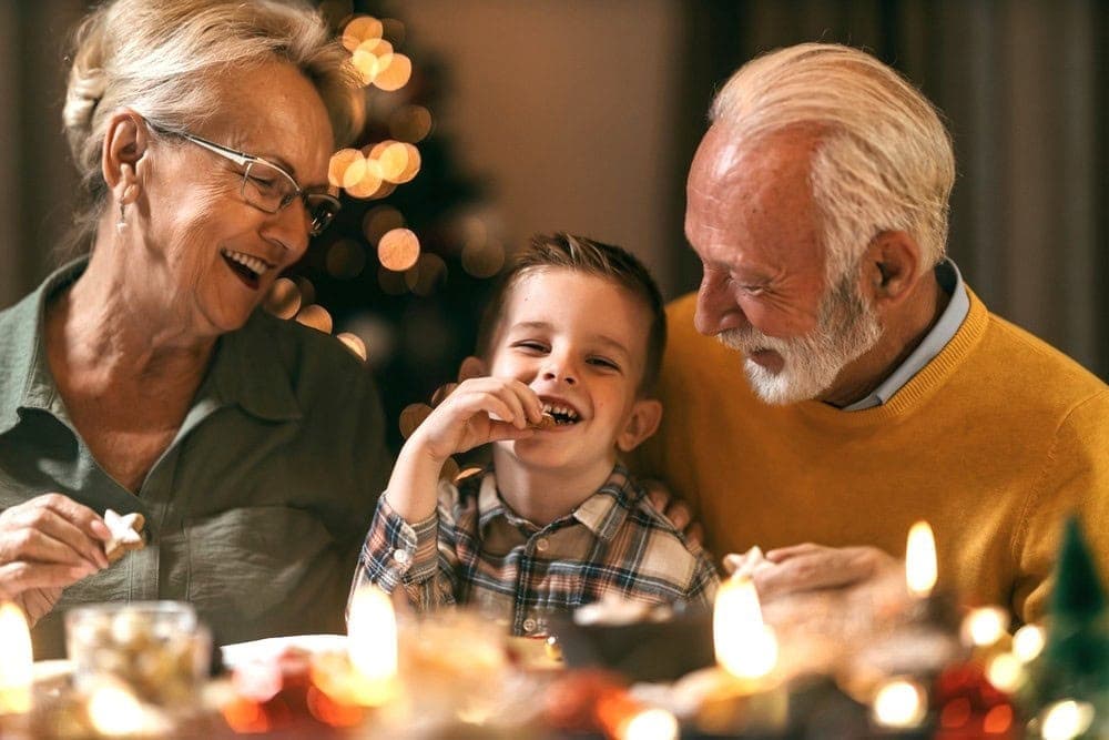 Grandparents and their grandchild enjoying a meal