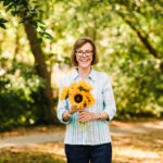 woman holding sunflowers