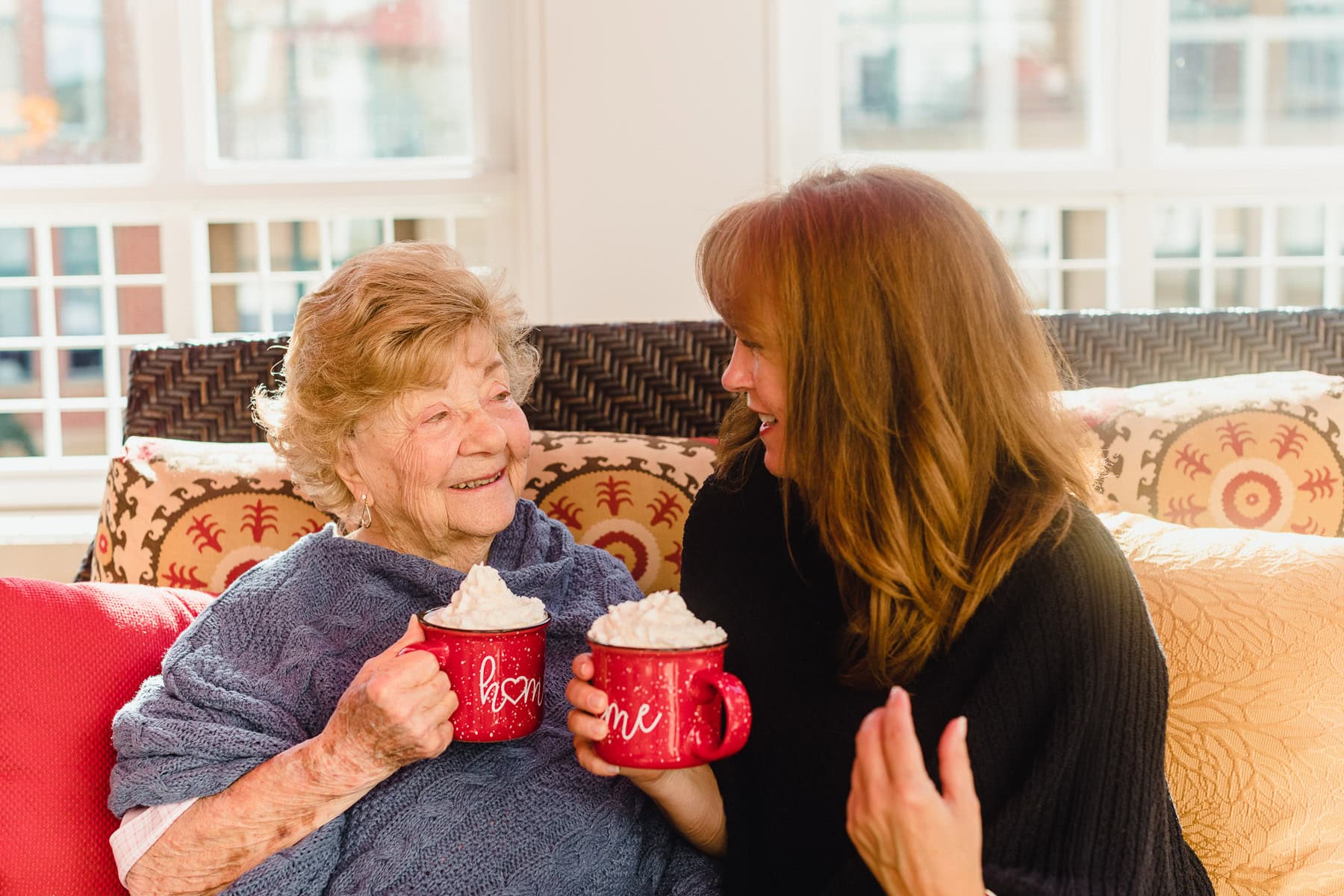 Aging Mother and Daughter drinking hot cocoa