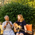 women singing and playing guitar